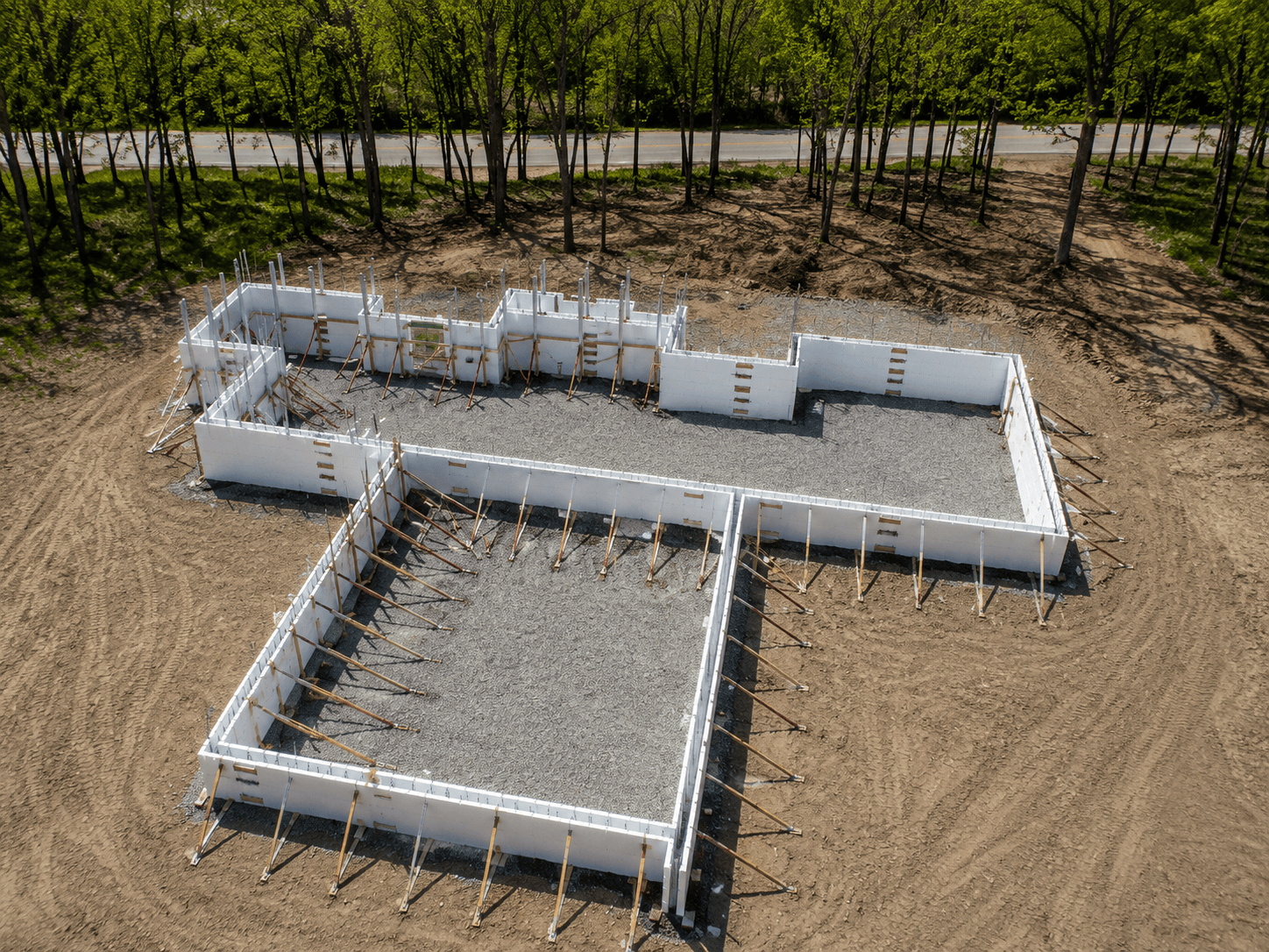 ICF foundation walls on a wooded construction site